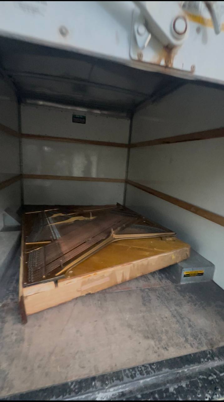 Dismantled piano frame loaded inside the removal truck